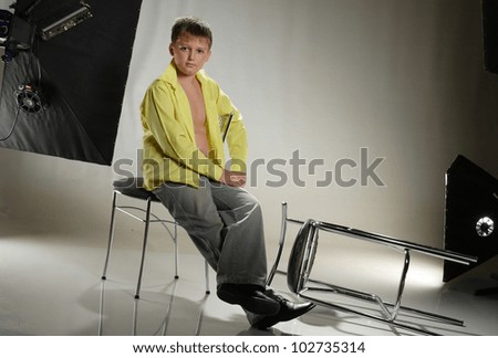teenager in a yellow shirt on studio shooting