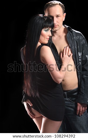 young people in love on black background