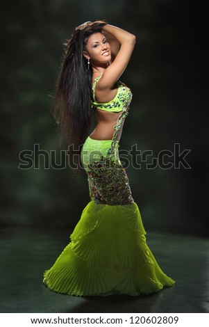 beautiful girl dancing in a green dancing dress