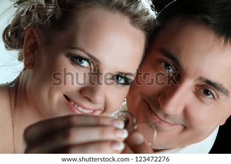 portrait of the bride and groom with wedding rings