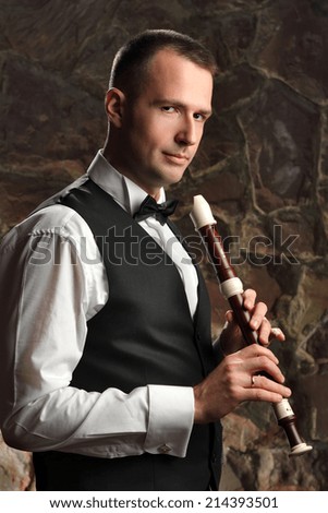 portrait of the groom musician with panpipe. wedding day. musical instrument.