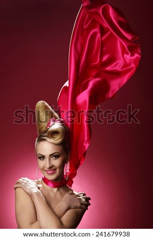 woman with trendy makeup and stylish hair in the wind. red shawl in the wind, well maintained body, beautiful smile