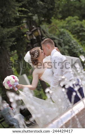 bride in the park near the fountain. happy emotions. the dance moves .kiss