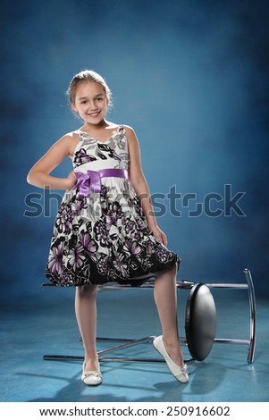 little girl with the chair. good emotions. studio