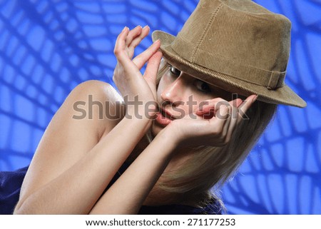 young beautiful woman in hat . flirty look. Game emotions. beautiful figure . photo on the background of the web