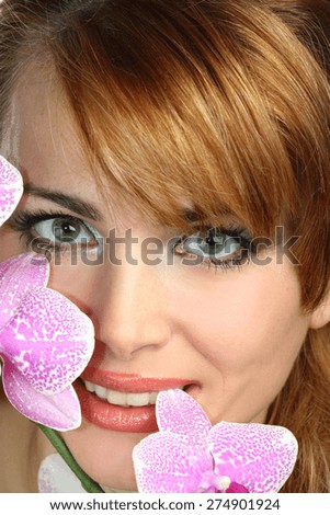 portrait of a young woman with orchids. stylish makeover. beautiful emotions.