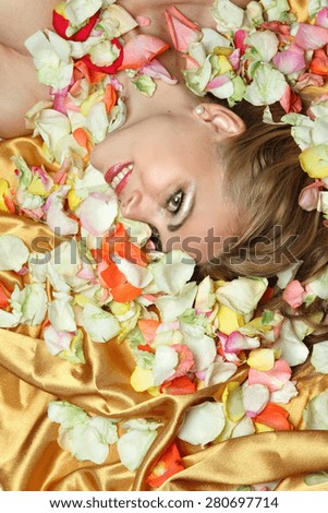 portrait of a young woman with petals of roses. beautiful emotions, good makeup