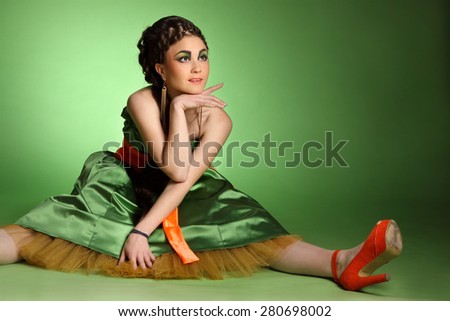 active model on a green background . stylish hairstyle, make-up art, studio photos, interesting image