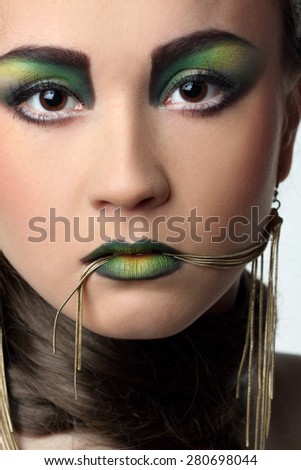 portrait of a young woman, stylish hairstyle, make-up art, studio photos, interesting image