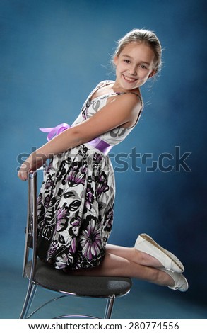 little girl with the chair. good emotions. studio