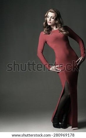 active fashion model in bright red evening dress. beautiful sexy figure, fashion model posing