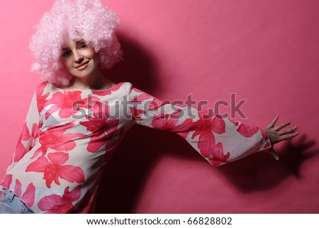 portrait of a young girl with pink hair pink background