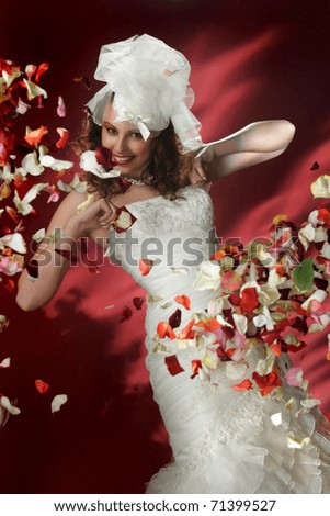 portrait of bride with rose petals on the background of fire