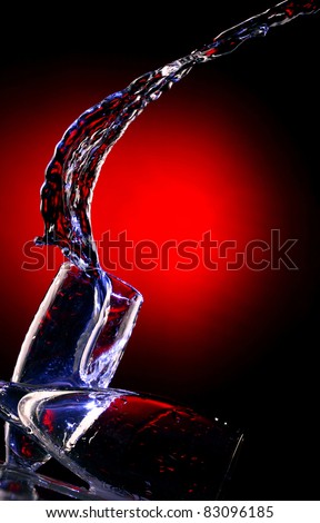 beautiful composition of water bursts with wine glasses