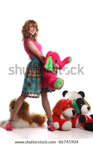 red-haired girl on white background with soft toys
