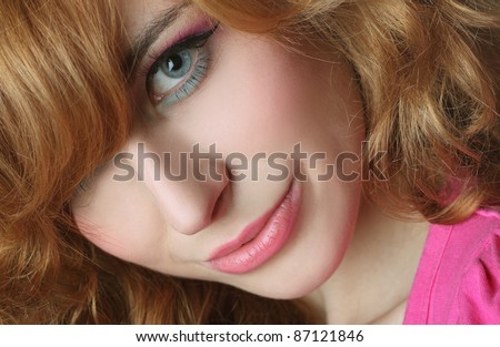 Portrait of a red-haired, blue-eyed girl on white background