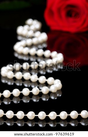 elegant rose with pearls on a black background
