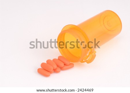 Generic orange pills spill from generic orange prescription bottle