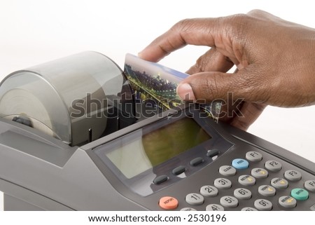 A credit card is swiped in a credit card machine