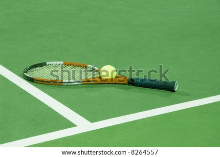 Tennis racquet and ball on tennis court under fluorescent lights at night, ideal for desaturation to black and white