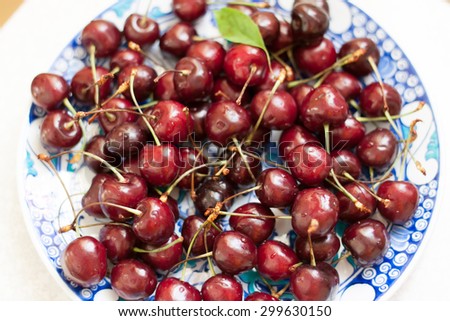 juicy cherries on a beautiful plate with oriental motifs