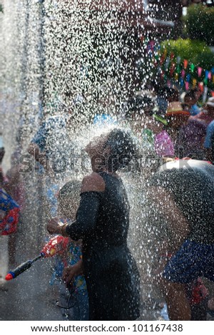 AYUTTAYA,THAILAND- APRIL 13: Man celebrate Songkran (New year / water festival: 13 April) by giving water to each others on April 13, 2012 in Ayuttaya, Thailand.