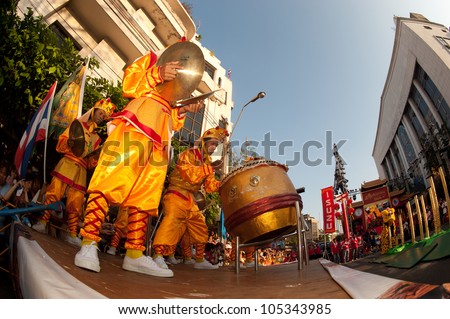 BANGKOK- THAILAND-JANUARY 24: Chinese Lion jumping on the Mei flower poles in Chinese New Year Festival on January 24, 2012 in Bangkok. It hesitates for further jumping or going back.