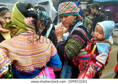 BAC HA, VIETNAM - AUG 29: Unidentified women of the Flower H\'mong Ethnic Minority People at market on August 29, 2011 in Bac Ha, Vietnam. H\'mong are the 8th largest ethnic group in Vietnam.