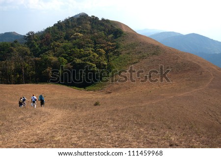Three persons trekking on high mountain in Northern of Thailand.