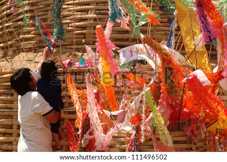 CHIANG MAI THAILAND - APRIL 14 : In Songkran festival or Water festival, Thai people pin traditional flags on sand pagoda. April 14,2011 in Phan-Tao Temple, Chiangmai province, Northern of Thailand.
