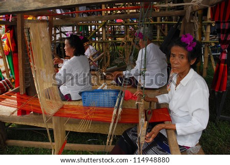 NAN,THAILAND - SEPTEMBER 26 : Hill  tribe woman weaving on September 26, 2011 in hill tribe village, Nan province,Thailand. Hill tribe women are minority of Thailand exploited for tourism reasons .