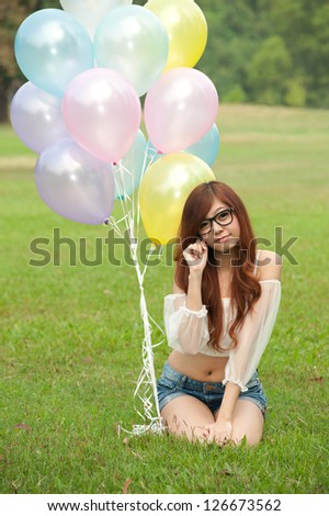 Happy girl  with balloon in the garden.