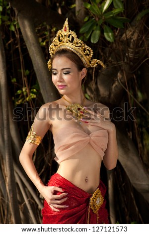 Pretty Thai woman posing in Thai ancient dress .