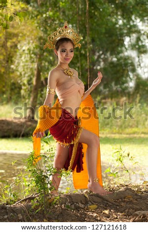 Pretty Thai woman posing in Thai ancient dress .