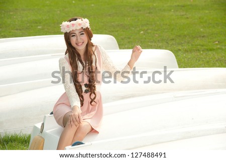 Pretty Asian woman posing on the boat .