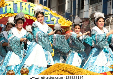 NAKORNSAWAN,THAILAND-FEB 13 : Unidentified beautiful woman provide music and Dance on the parade during Chinese New Year celebrations on February 13, 2013 in Nakornsawan city,Middle of Thailand.