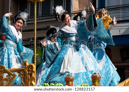NAKORNSAWAN,THAILAND-FEB 13 : Unidentified beautiful woman provide music for  Dance on the parade during Chinese New Year celebrations on February 13, 2013 in Nakornsawan city,Middle of Thailand.