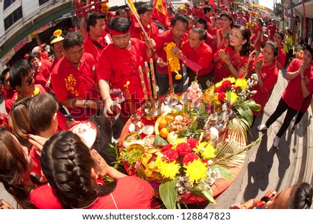 NAKHONSAWAN, THAILAND-FEB 13 : Oracle (a medium who communicate with spirits) of gods doing ritual at worship table of people in Chinese New Year Celebrations on February 13, 2013 in Thailand .