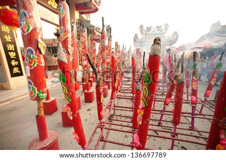 SUPUNBURI,THAILAND- FEB 13 : Unidentified people worship with big incense during Chinese New Year celebration in City Pillar Shrine Chinese temple on 13 February 2013 in Supunburi ,Thailand.