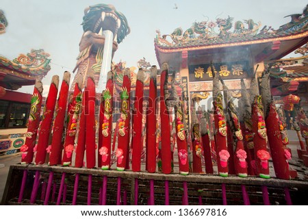 SUPUNBURI,THAILAND- FEB 13 : Unidentified people worship with big incense during Chinese New Year celebration in City Pillar Shrine Chinese temple on 13 February 2013 in Supunburi ,Thailand.