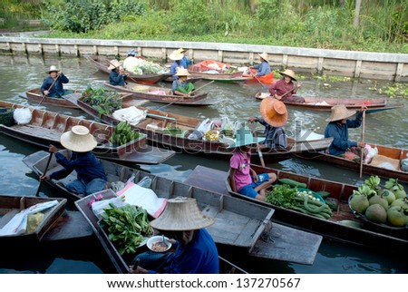 SAMUTSONGKRAM, THAILAND - FEB 6 : Busy people at Taka floating market. A  traditional but popular method of buy and sell still practised in the canals on Feb 6,2013 in Samutsongkram, Thailand.