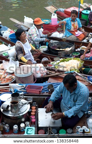SAMUTSONGKRAM,THAILAND-SEPT 6 : Men working coffee on his boat in Amphawa evening floating Market famous floating market and cultural tourist destination on Sept  6, 2012 in Samutsongkram, Thailand.