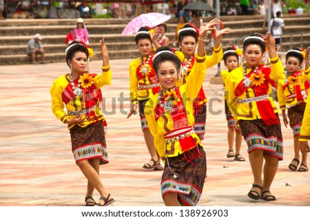 YASOTHON,THAILAND - MAY 12 : Unidentified woman traditional dancing on parades in Rocket festival. The celebration for plentiful rains during the rice plant season,on May12,2013 in Yasothon,Thailand.