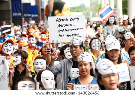 BANGKOK,THAILAND-JUNE 16 : Unidentified demonstrators from the anti- government  V for Thailand group wearing  Guy Fawkes masks attend rally on public traffic road on June 16,2013 in Bangkok,Thailand.