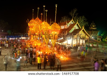 LOEI,THAILAND- APRIL 14 : Thai villagers carrying the flower parade in worship around the Church with joy and fun at Wat Sri  Pho Chai temple on April 14,2013 in ,Loei Province,Northeast of Thailand.