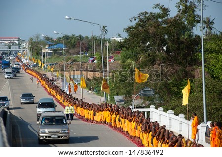 BANGKOK,THAILAND-JAN 21 : Row of Buddhist hike Thai monks on streets strewn with rose petals on the Thammachai hike establish the path of the great teachers on January 21,2012 in Bangkok , Thailand
