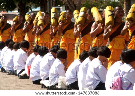 BANGKOK,THAILAND-JAN 21 : Row of Buddhist hike Thai monks on streets strewn with rose petals on the Thammachai hike establish the path of the great teachers on January 21,2012 in Bangkok , Thailand