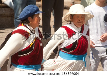 LIJIANG,CHINA-MARCH 17: The people Naxi nationality old woman of traditional dance on March 17,2014 in Dayan Old Town of Lijiang ,Yunnan Province in China.The Lijiang is a tourist city of China.