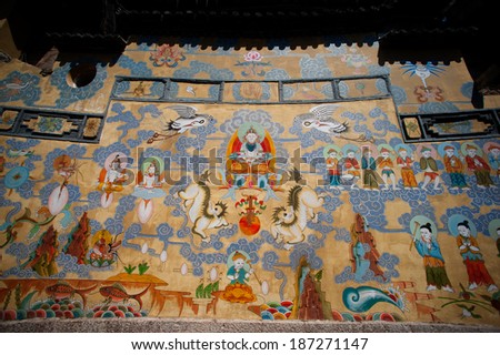 LIJIANG,CHINA - MARCH 17: Tibetan art murals on building in Lijiang is the largest ancient old town on March 17, 2014 in China. It was enlisted as a UNESCO World Heritage List on December 4, 1997 .
