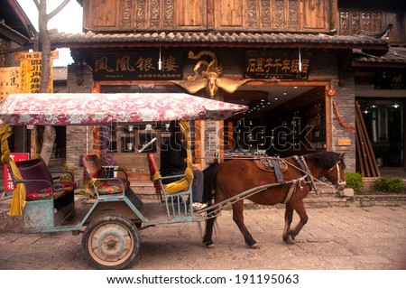 LIJIANG,CHINA - MARCH 16: Carriage walking around Shuhe ancient town for tourists service on March 16,2014.Shuhe is the ancient old town in Lijiang city , Yunnan province in Southwestern of China.